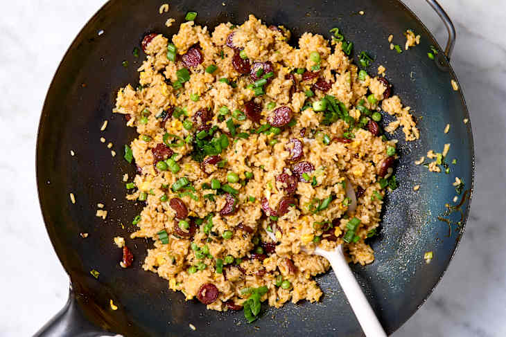 Overhead shot of Chinese sausage fried rice in a wok.