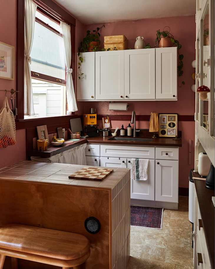 White cabinets in pink painted kitchen