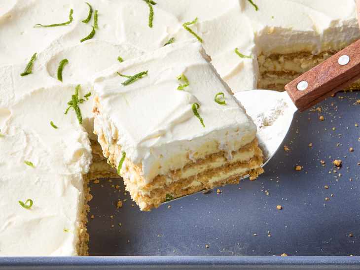 angled shot of a single slice of key lime ice box cake being pulled from the rest of the cake