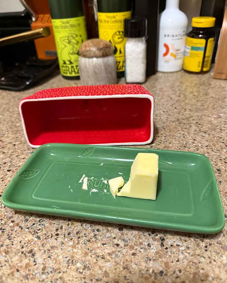 Lid off strawberry butter dish.