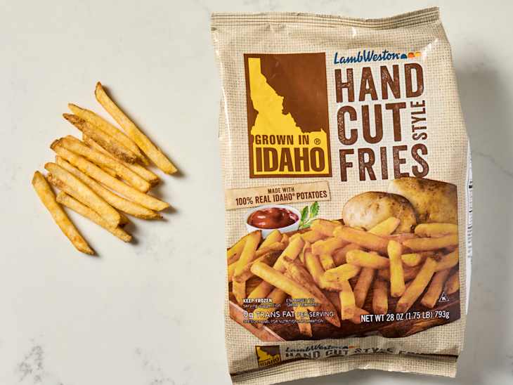 Hand-cut fries arranged beside a bag labeled "Hand Cut Style Fries" with images of fries and potatoes.