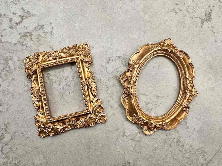 Two gold frames on surface.
