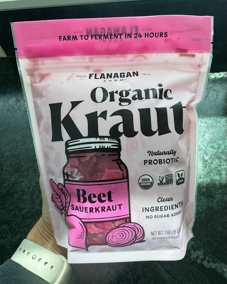 Someone holding a package of Flanagan Farm Organic Kraut.