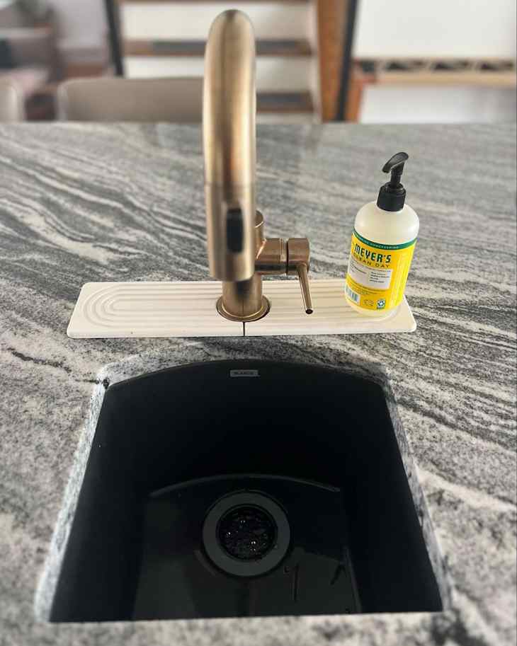 Faucet mat around kitchen sink.