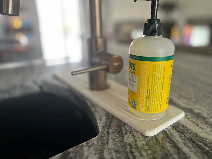 Faucet mat around kitchen sink.
