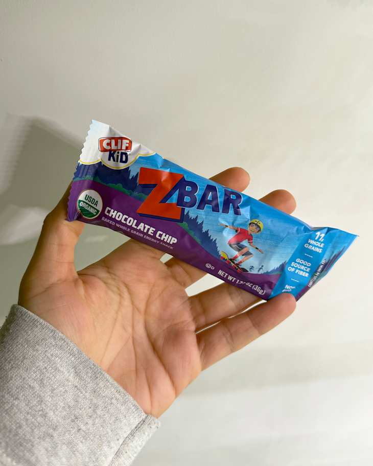 Someone holding a Clif Kid Z Bar, chocolate chip flavor