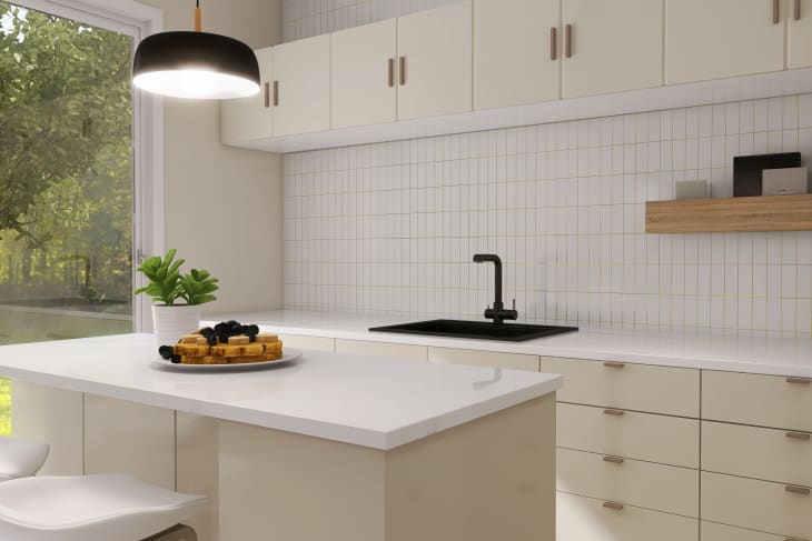 Modern, luxury kitchen with ivory cream built in cabinet, cupboard, kitchen island and white tile splashback in sunlight from glass door for interior design,