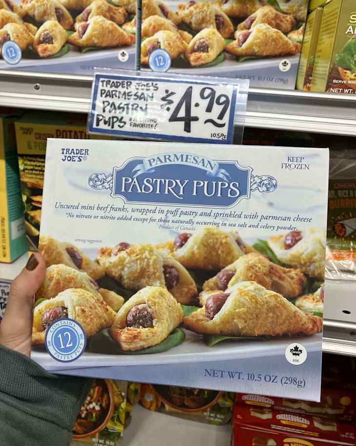 Someone holding Trader Joe's parmesan pastry pups.