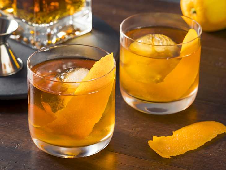 Homemade Boozy Old Fashioned Cocktail with Whiskey and a Sphere Ice Cube