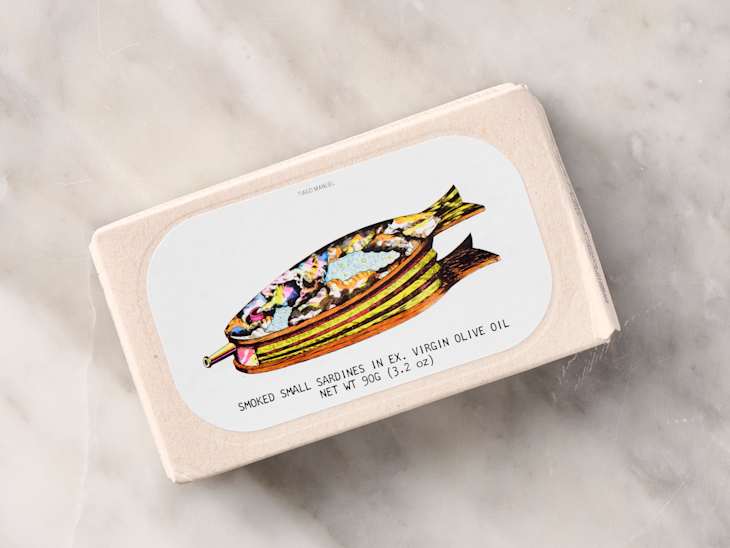 Colorful packaging for smoked sardines in olive oil, featuring a fish illustration and product details.