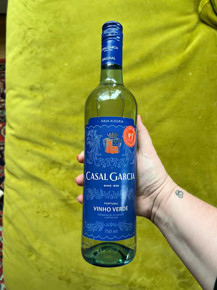 Hand holding a bottle of Casal Garcia Vinho Verde