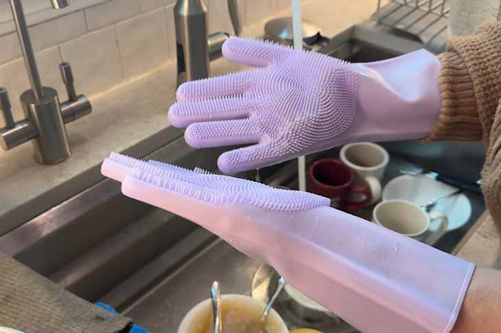 Palms splayed to show silicone scrubbing gloves.