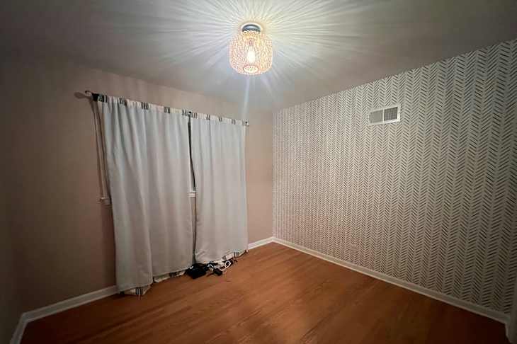 Wallpaper in bedroom before being staged.