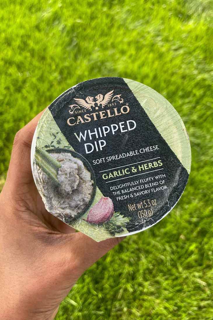 Container of Castello whipped dip with garlic and herbs.