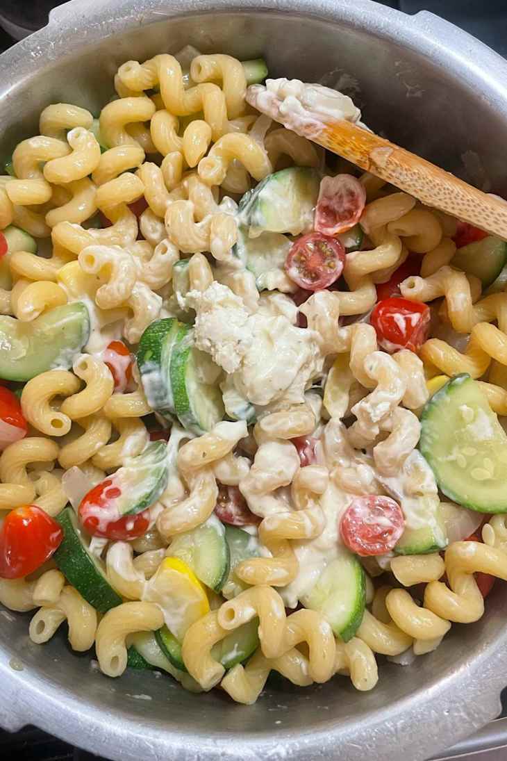 Creamy pasta with corkscrew noodles, cherry tomatoes, and zucchini.