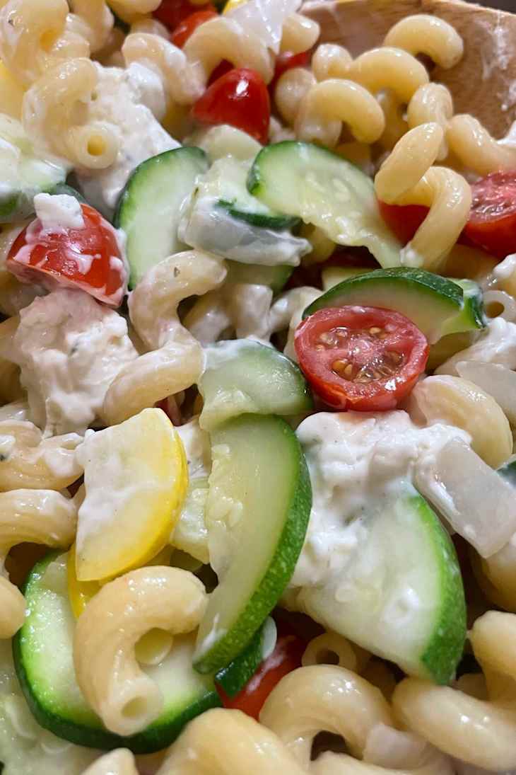 Creamy pasta with corkscrew noodles, cherry tomatoes, and zucchini.