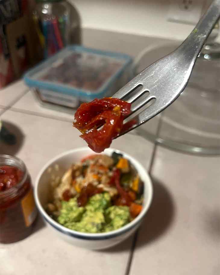 Sun dried tomatoes on fork.