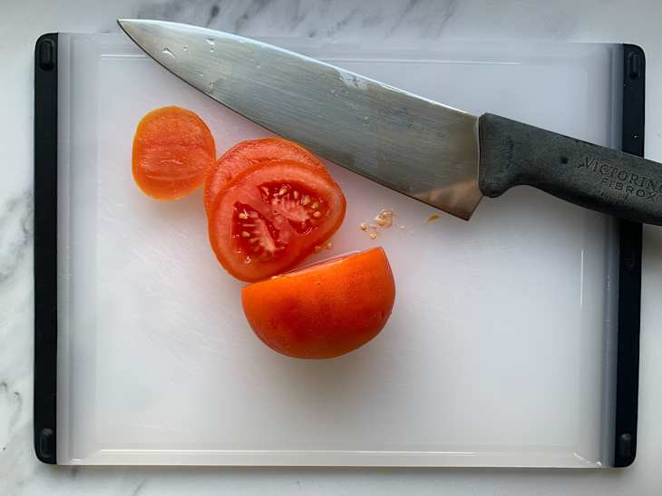 Sliced tomato using Victorinox chef's knife.
