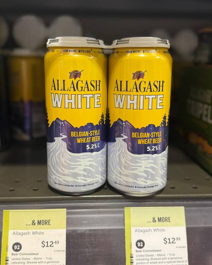 Allagash White beer cans on shelf at grocery store