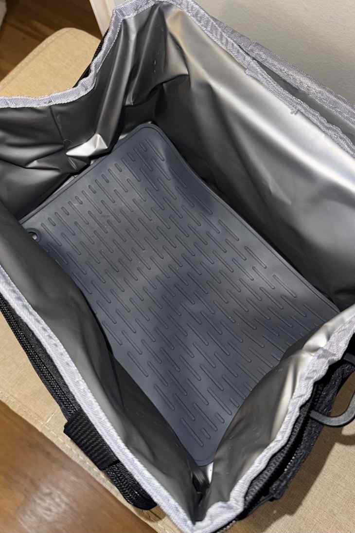 A cooler with a dish drying mat.