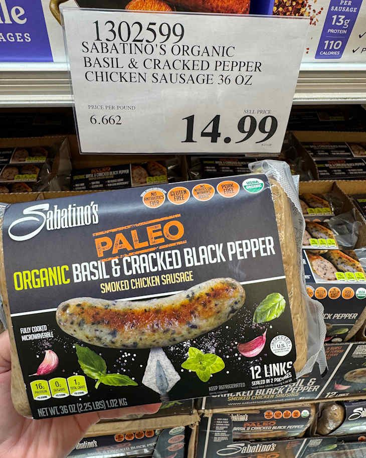 Someone holding package of paleo sausage.