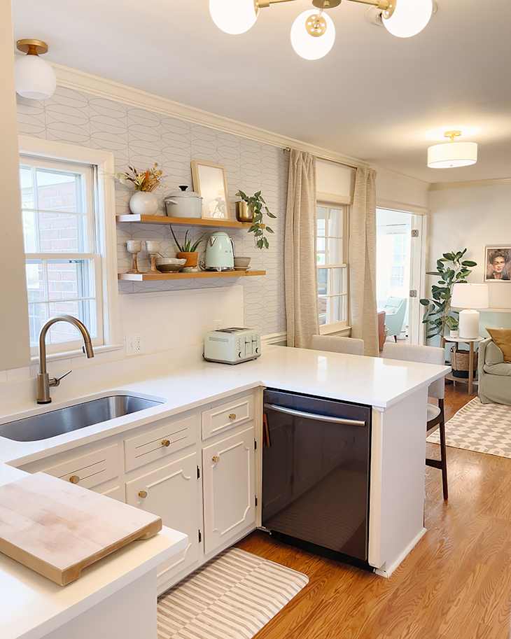 white kitchen with white cabinets with modern pulls, and updated light fixtures after makeover