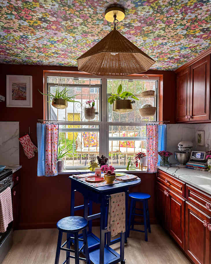 Wicker light hanging on colorful ceiling of newly decorated kitchen.