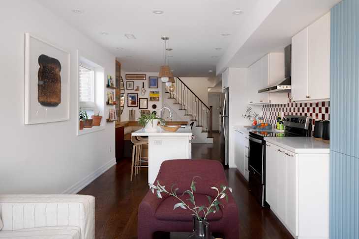 Wicker pendants hung over white kitchen island.