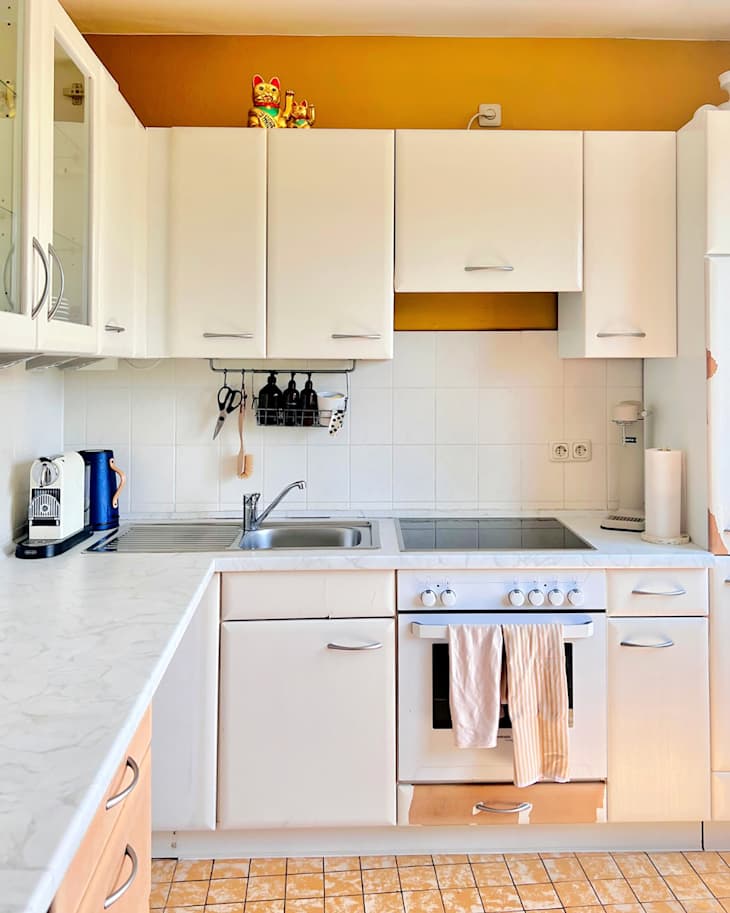 White cabinets in kitchen before painting green.