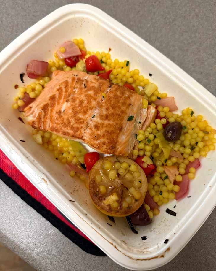 Salmon and couscous meal in tray.