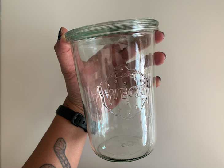 Someone holding Weck canning jar.
