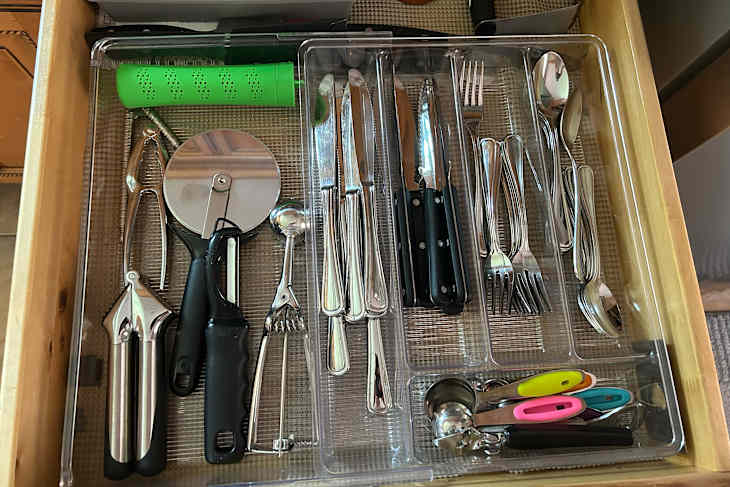 Organized kitchen silverware drawer.