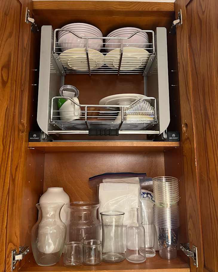 Plates organized in kitchen cabinet using Rev-A-Shelf Kitchen Pull-Down Wall Cabinet Shelf System