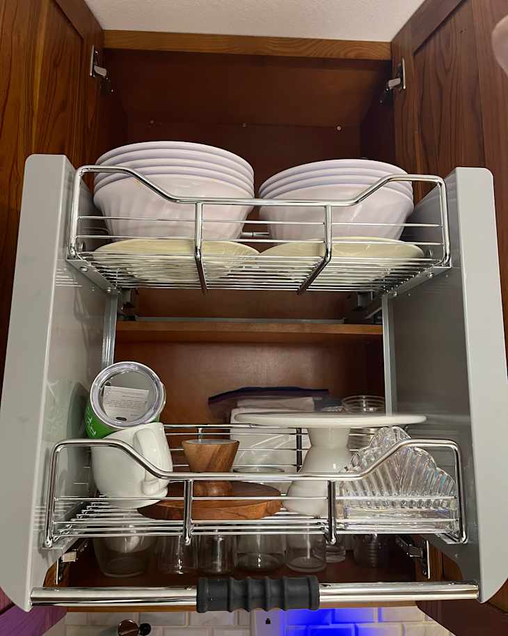 Plates organized in kitchen cabinet using Rev-A-Shelf Kitchen Pull-Down Wall Cabinet Shelf System