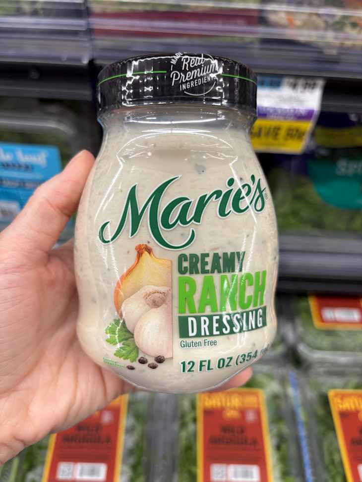 Marie creamy ranch dressing jar held in hand,