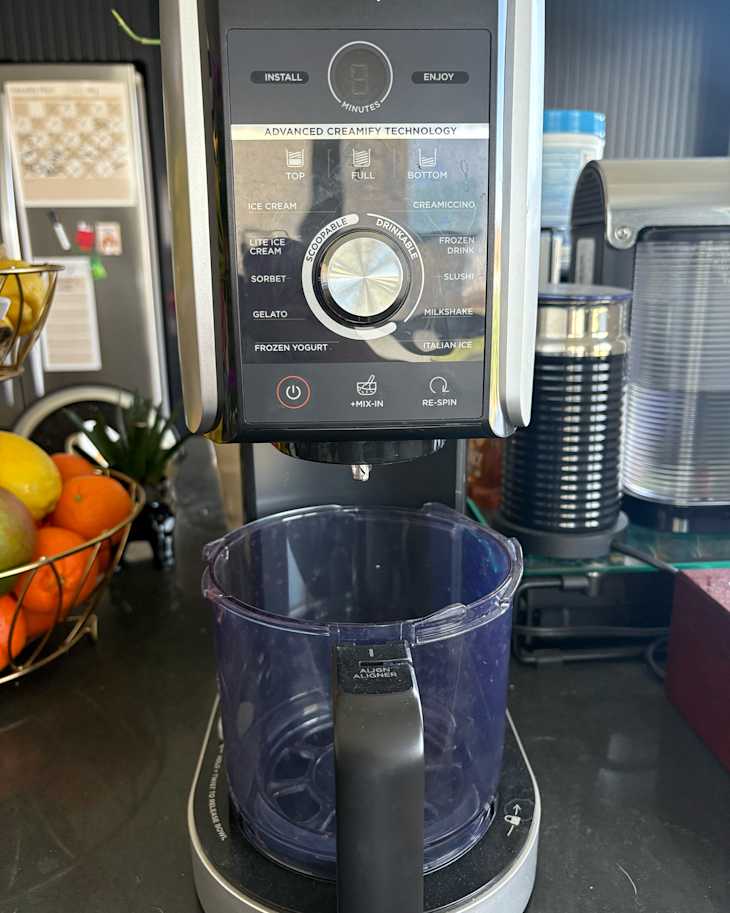 Ninja creami ice cream maker on kitchen countertop.