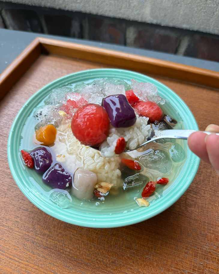 Someone scooping up ice rice in spoon.