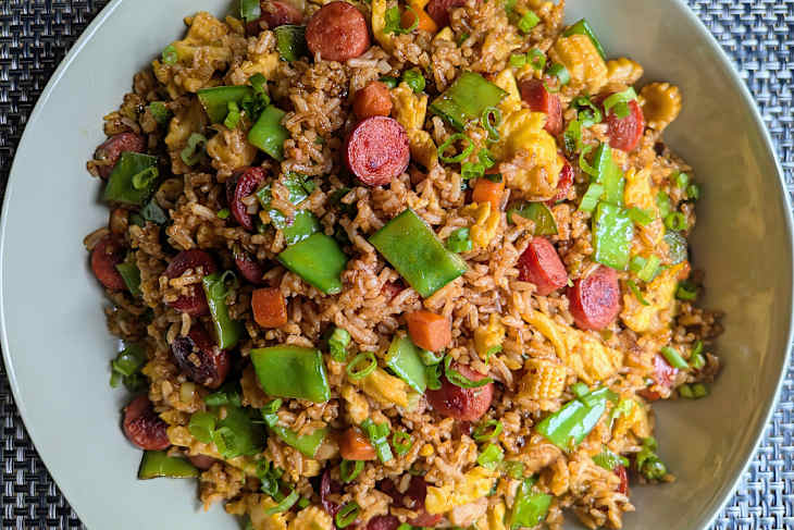 plate of hot dog fried rice with scallions