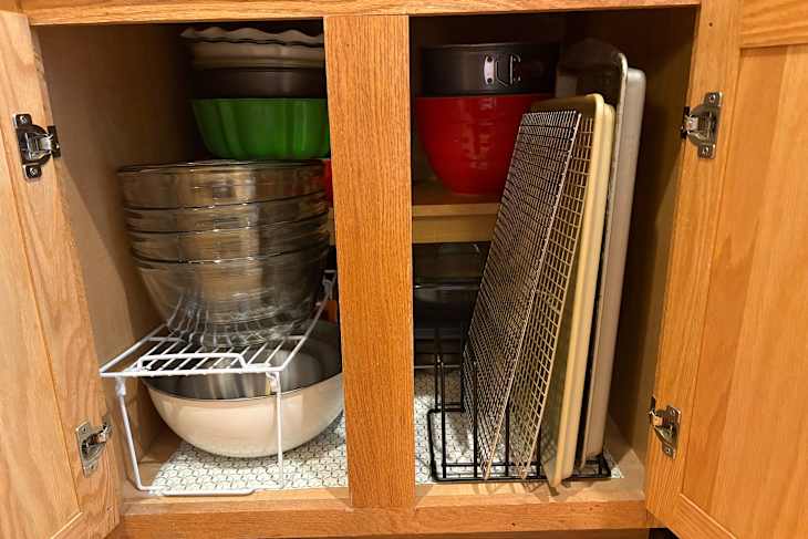 Bakeware organized in cabinet.