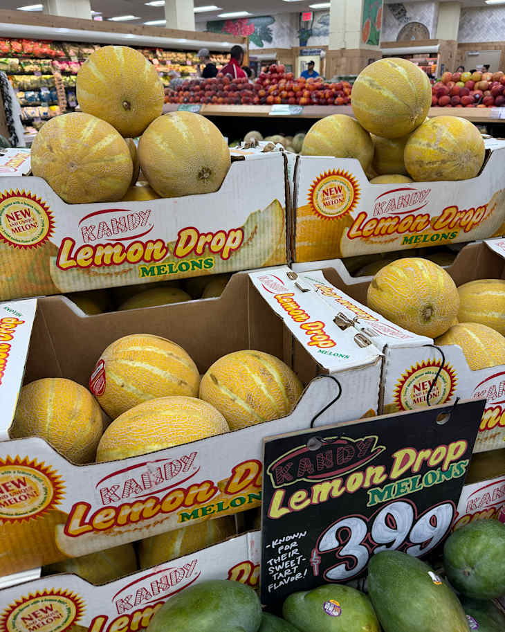 Lemon Drop melons on display in grocery store.