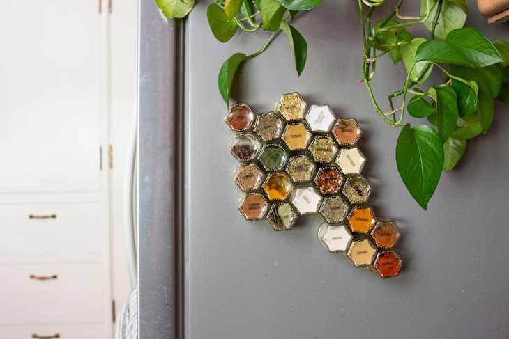 Magnetic spice jars on refrigerator.