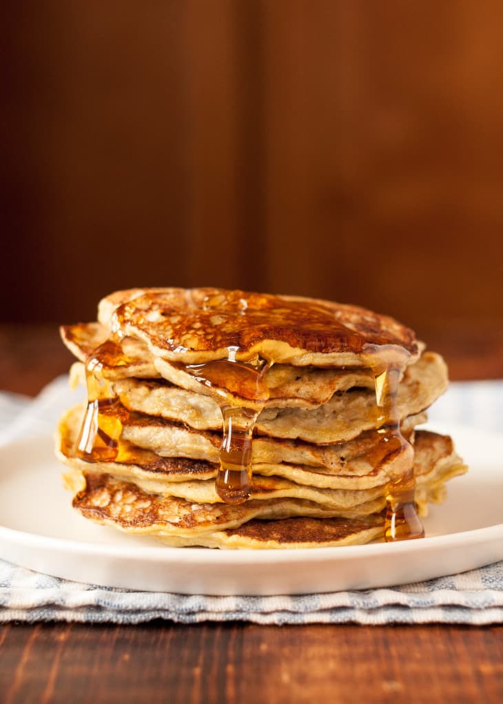 Stack of banana pancakes covered with syrup