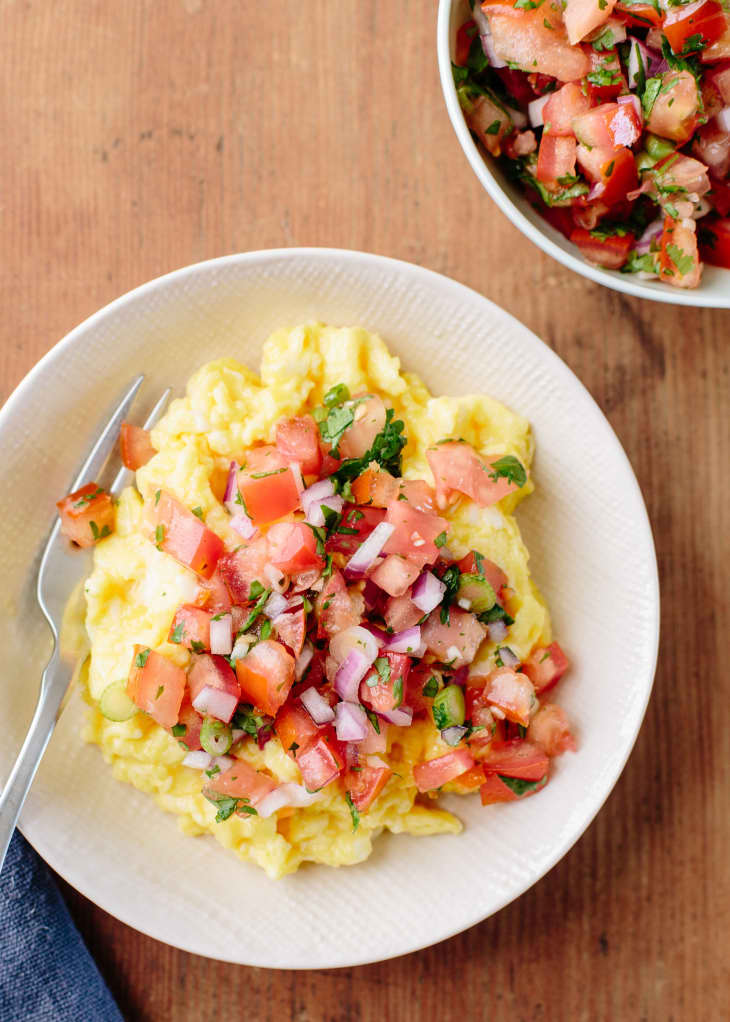 A bowl of scrambled eggs with pico de gallo