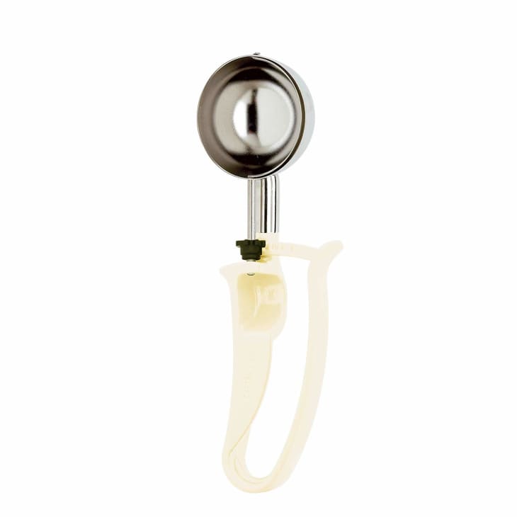 Metal ice cream scoop with a beige handle and a thumb lever.