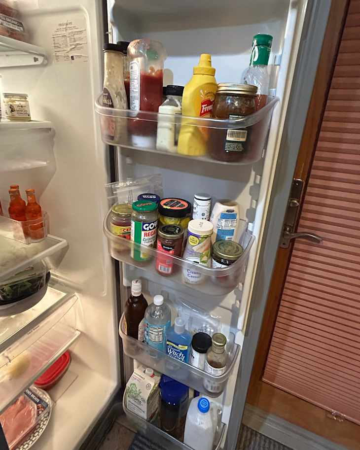 Condiments in door of refrigerator before using quadrant storage trick.