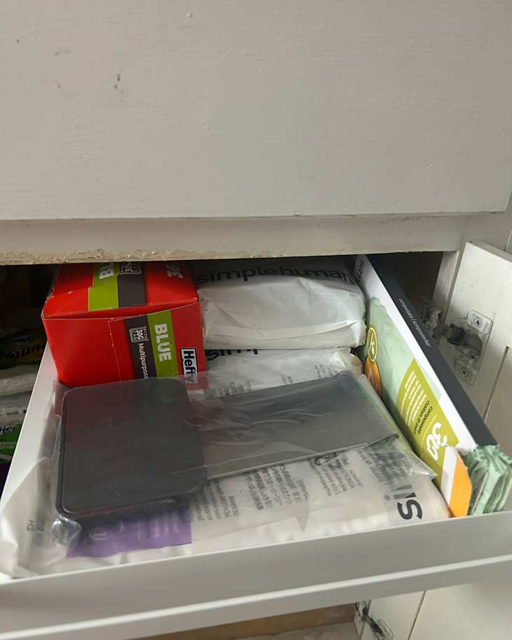 Trash bags in Yamazaki under sink pull out shelf system.
