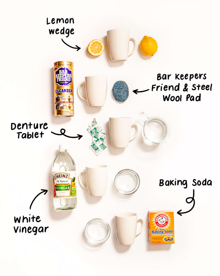 Cleaning supplies for mugs: lemon wedge, Bar Keepers Friend, steel wool pad, denture tablets, white vinegar, baking soda.