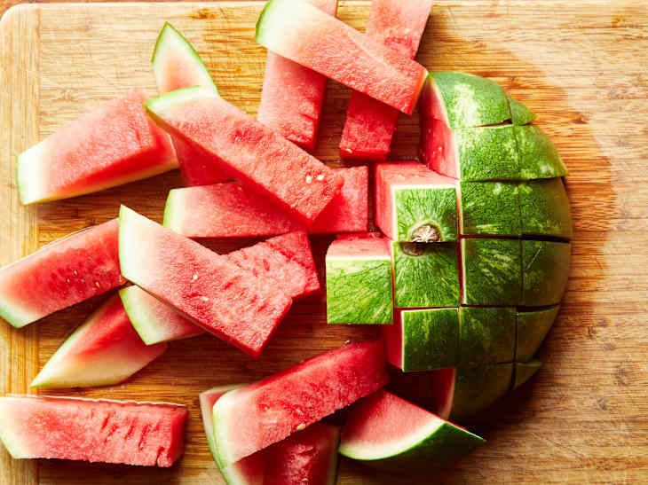 The watermelon slices lay on a cutting board.