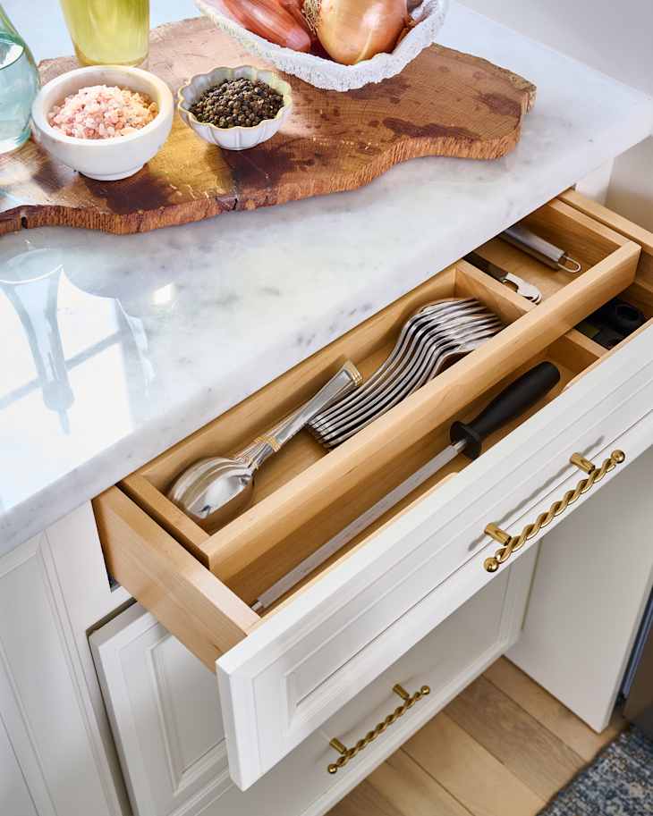 Drawer pulled out showing organized silverware.