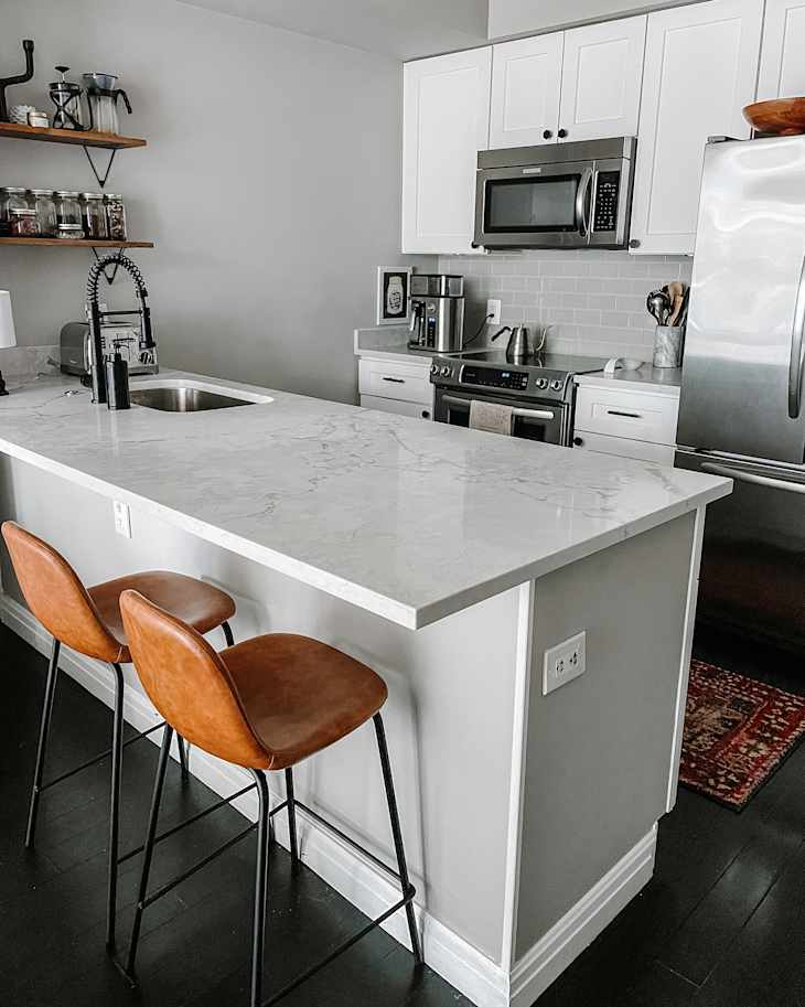White and gray kitchen with mixed materials countertop